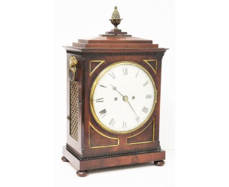 A Regency mahogany bracket clock with stepped top surmounted with acorn finial, gilt brass handles and pierced side panels, r