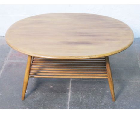 An Ercol light elm and beech oval coffee table. L99cm H44cm