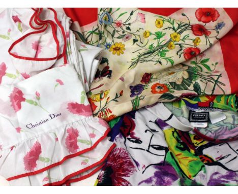 Vintage textiles comprising Christian Dior king size bed linen and pillow cases, a Gucci silk scarf and a pair of Versace leg