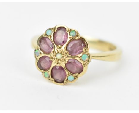 A 9ct yellow gold, amethyst and opal flower ring, the six oval cut amethysts formed as petals with cabochon opals in between 