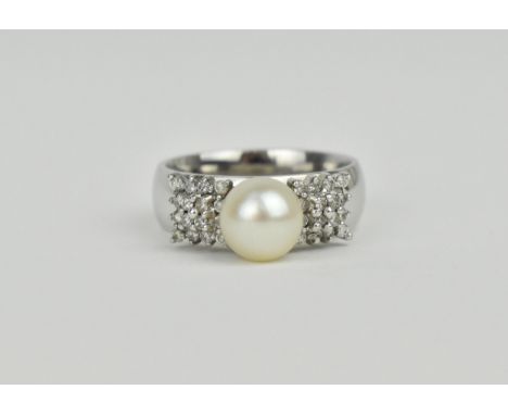 An 18ct white gold, diamond and pearl dress ring, the central pearl flanked with square shaped clusters of sixteen diamonds e