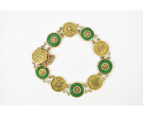 A Chinese yellow metal and green jade bracelet, with five green jade bi discs with yellow metal mounts, with open box clasp a