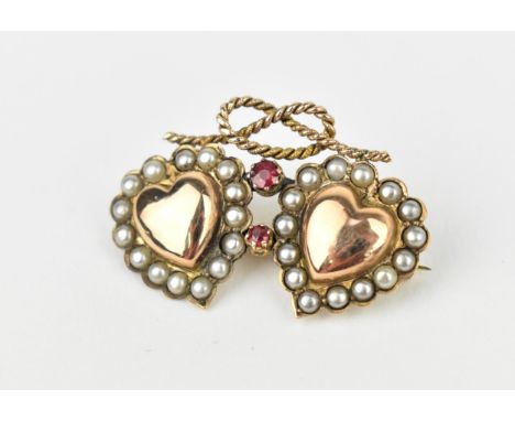 A Victorian 9ct gold, ruby and split pearl double heart brooch, with rope knot above the two hearts, each with a pearl surrou