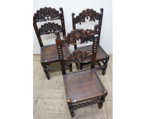Set of three similar carved oak dining chairs with solid seats, on bobbin turned supports 