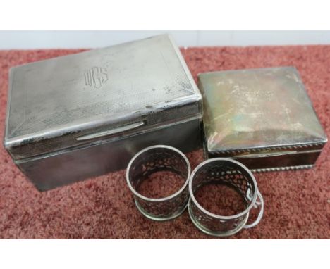 London silver hallmarked cigarette box with hinged detail and engine turned detail and a pair of silver hallmarked napkin rin