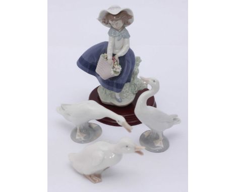 A Lladro porcelain figure 'Pretty Pickings' Model No.5222, together with two Lladro figures of geese and a small NAO porcelai