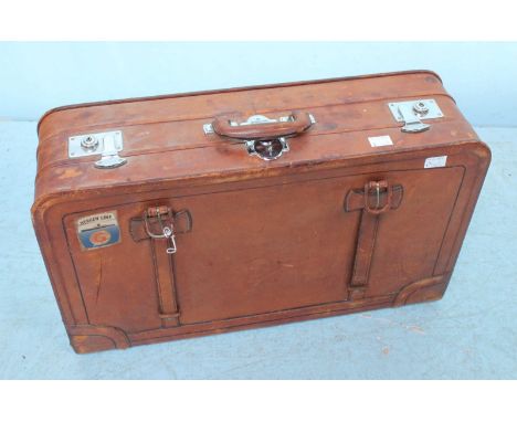 A vintage brown leather suitcase. 65cm wide.