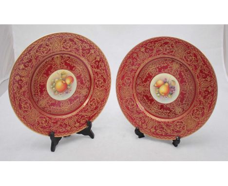 A pair of Royal Worcester cabinet plates, the central roundels painted with bunches of fruit, one signed by 'Telford' and bot