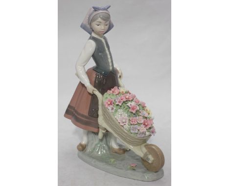 A Lladro ceramic figure-group 'A Barrow of Blossoms' model number '1.419' in original box. 23.5cm high.