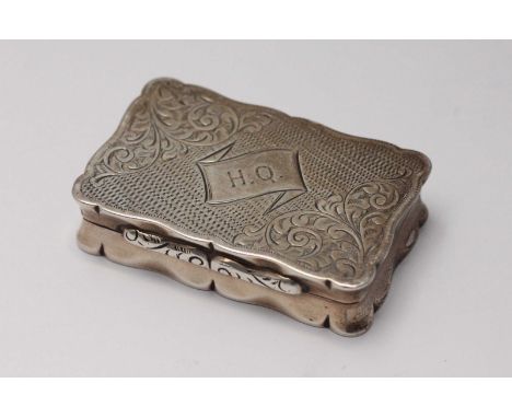 A 19th century silver snuff box of rectangular form with hinged cover, engine turned and engraved scrolling foliate decoratio
