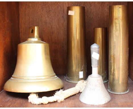 A hand bell reputably from a WW2 German U-Boat together with three brass artillery shells and a brass ship's bell