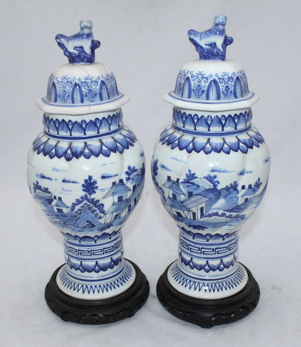 A Pair Of Delft Blue And White Pottery Vases With Covers Raised