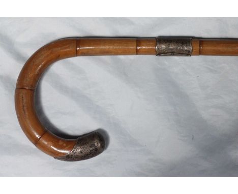 A silver-topped bamboo walking cane, Birmingham 1923, together with a silver pocket cigarette case of curved form with engine