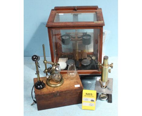 An Oertling oak cased set of chemical balance scales including a cased set of weights, together with a Vickers microscope wit