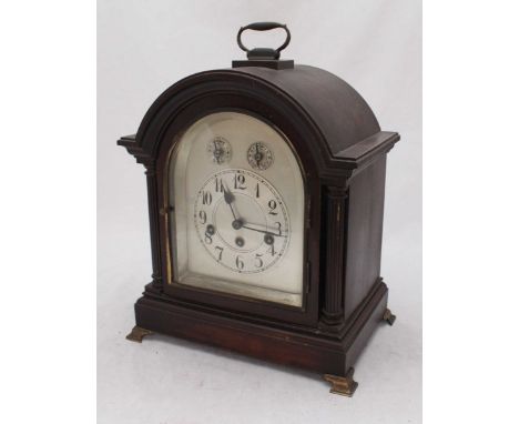 An early 20th century mahogany mantle clock, with silvered dial, Arabic numerals and subsidiary dial to the arch, movement ma