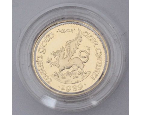A 1989 Welsh gold medallion, harp to one side, dragon to the other, 1/4oz, in original case