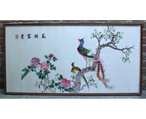 A large Oriental silkscreen panel depicting colourful birds of paradise on a branch with flowers, glazed and framed, approxim