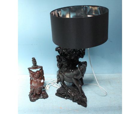 A large black figural lamp of two Oriental men riding a Buffalo with black circular lampshade, approximately 80cm high, toget