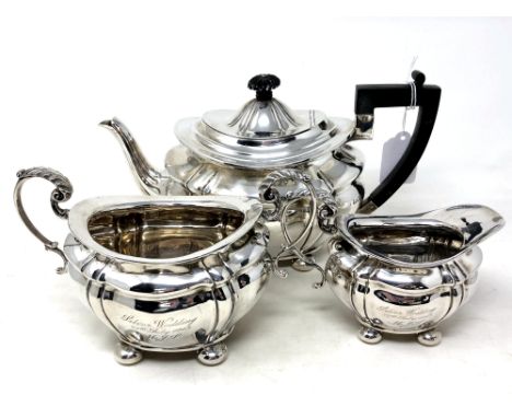 A silver three piece tea service, Josiah Williams &amp; Co, London 1900, engraved with an inscription, teapot 16cm high. (3) 