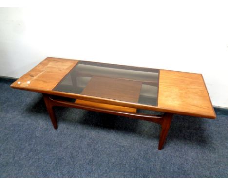 A teak G Plan coffee table with under shelf fitted with a smoked glass panel, length 137 cm 