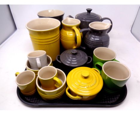 A tray containing ten pieces of ceramic Le Creuset kitchenware 