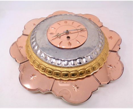 An Art Deco two tone glass wall clock in the form of a flower petal 