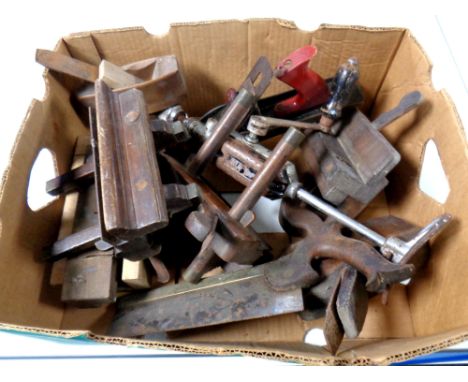 A box containing vintage woodworking tools to include hand planes, saws, hand drill  