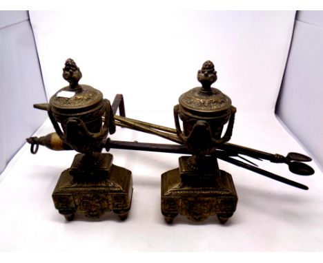 A pair of 19th century brass and cast iron fire dogs together with a toasting fork and three fire companion pieces   