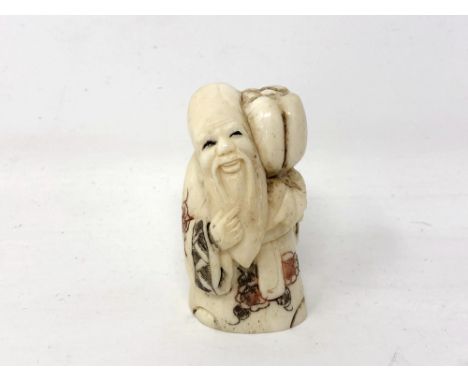 A Japanese carved bone netsuke - Village elder carrying a pumpkin on his shoulder. 