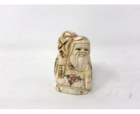 A Japanese carved bone netsuke - Village elder carrying a sack on his shoulder. 