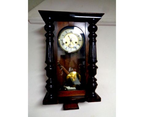 An Edwardian wall clock with brass and painted dial, plus pendulum and key 