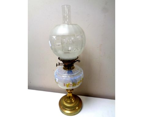 An antique brass oil lamp with hand painted opaque glass reservoir, chimney and shade, height 59 cm  