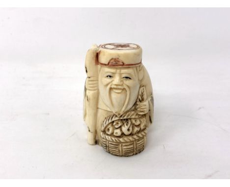 A Japanese carved bone netsuke - Village elder with a basket by his feet. 