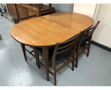 A 20th century oval teak extending dining table together with a set of four ladder back chairs  