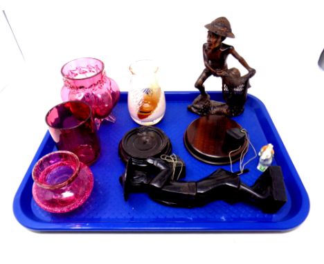 A tray containing oriental carved wooden figures, three pieces of cranberry glassware, Caithness glass vase 