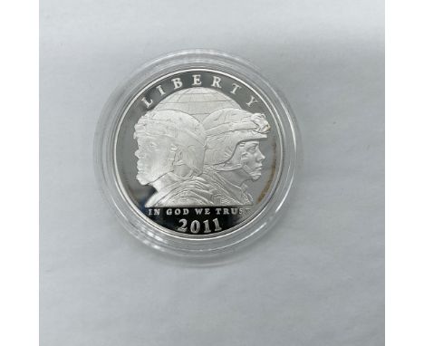 Philadelphia Mint. The obverse side depicts the profiles of a male and female soldier. The reverse side features the seven co