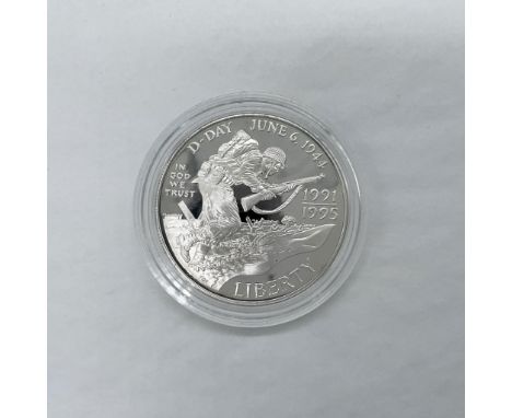 West Point Mint. The obverse side depicts Allied Forces storming the beaches of Normandy. The reverse side features a quote b