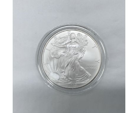 West Point Mint. I ounce. The obverse side depicts Liberty in full stride. She is shown wrapped in the flag, her right hand i