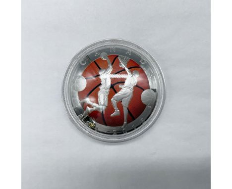 A commemorative coin celebrating the 125th anniversary of the invention of basketball. A convex-shaped coin, the obverse side