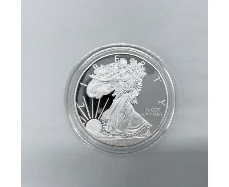 West Point Mint. The obverse side depicts Liberty in full stride. She is shown wrapped in the flag, her right hand is extende
