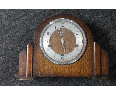 A 1930's oak Smiths Enfield mantel clock with pendulum  CONDITION REPORT: There is no key to wind it but the clock does tick 