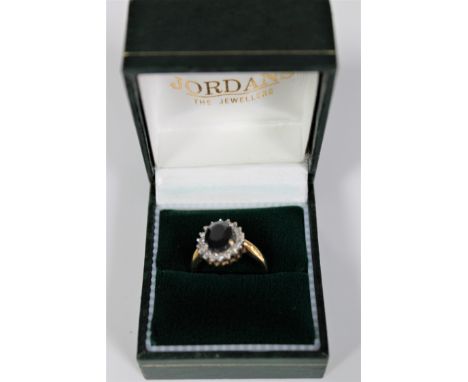 An 18ct gold diamond and sapphire cluster ring