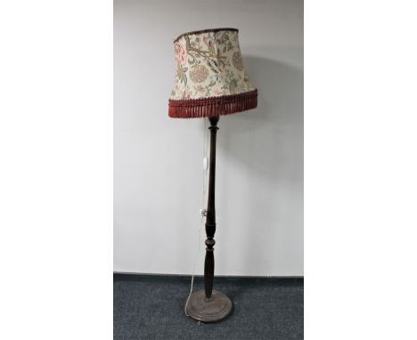 An antique mahogany standard lamp with shade 