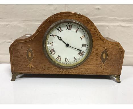 A late 19th century inlaid mahogany mantel clock on brass feet 
