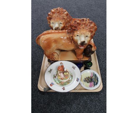 A tray of pair of Victorian Staffordshire lion figures, Hummel figure of a girl with chicks, two antique glass eye baths and 