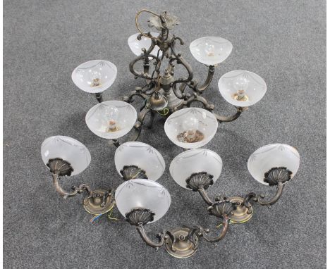 An ornate metal six way light fitting with glass shades together with three double wall lights (one lacking shade)