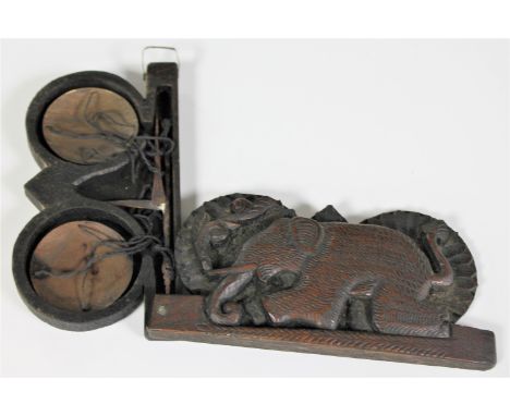 A set of 19th century opium scales in a carved hardwood case depicting an elephant 