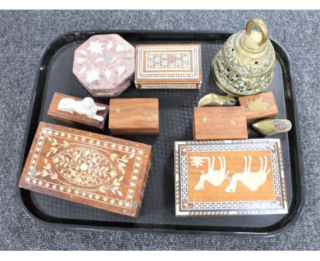 A tray of Eastern trinket boxes, brass bell, ivory figure of a sphinx on wooden base 