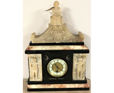 A 19th century slate mantel clock with brass and enamelled dial surmounted by a seated figure 
