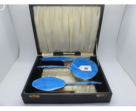 An Enamel Backed Three Piece Dressing Table Set, highlighted in blue, with a comb in original fitted case, bearing label "Rea